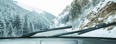 Car driving in the mountain with wiper blades on